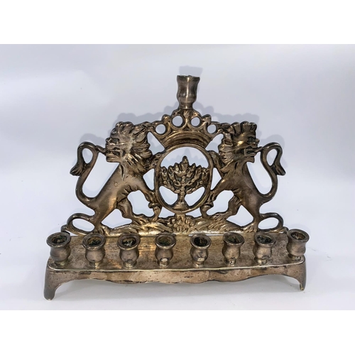 131 - A silvered metal Hanukkah light -Menorah with twin lions rampant width 21cm