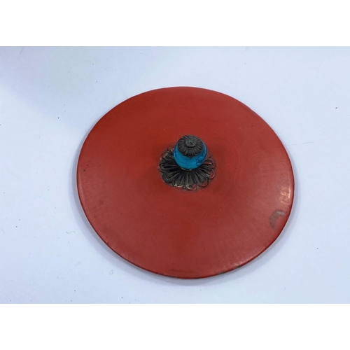 414 - A Japanese gram tetsubin decorated with flowers in relief, red lacquered lid and blue glass finial, ... 