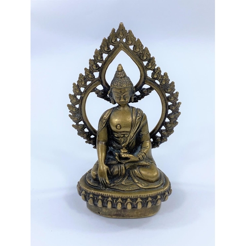 415 - A Far Eastern bronze figure of a seated buddha with pierced leaf shaped back rest, height 15cm