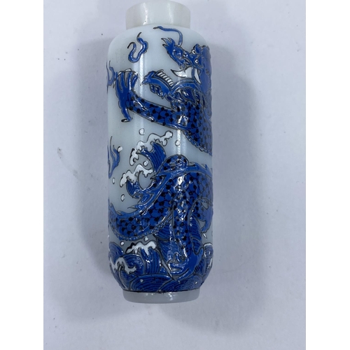423 - An opaque white Chinese snuff bottle with blue dragons to body, character mark to base, length 7.5cm... 