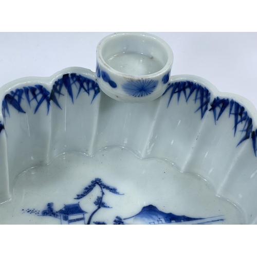 409 - A Japanese blue and white lobed bamboo effect ceramic bowl with plant and traditional decoration, wi... 