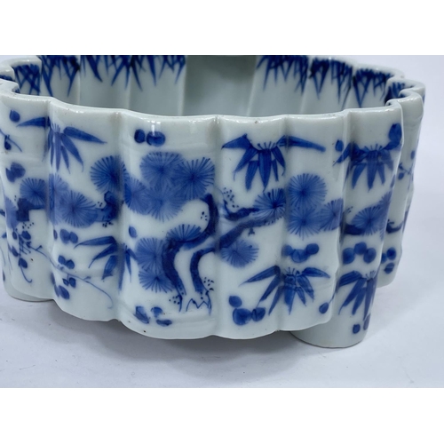 409 - A Japanese blue and white lobed bamboo effect ceramic bowl with plant and traditional decoration, wi... 