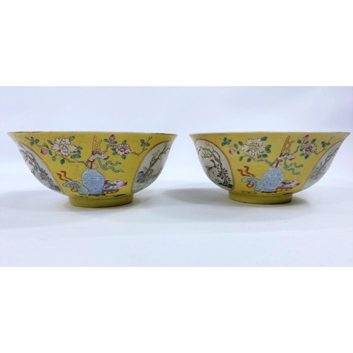 411 - Apair of Chinese yellow glaze bowlswith exterior panels depicting vases and animals, blue and white ... 