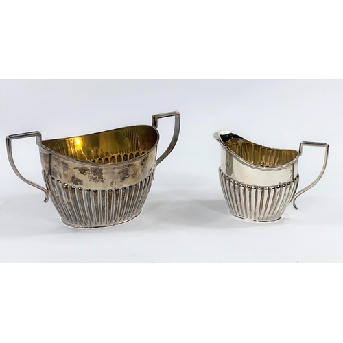 689 - A milk jug and sugar bowl in Georgian fluted oval style, Chester 1923, 13 oz
