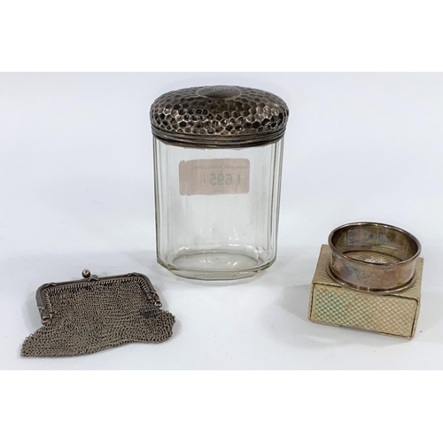 695 - A silver chain sovereign purse; a cut glass powder jar with silver top; a napkin ring, total weight ... 