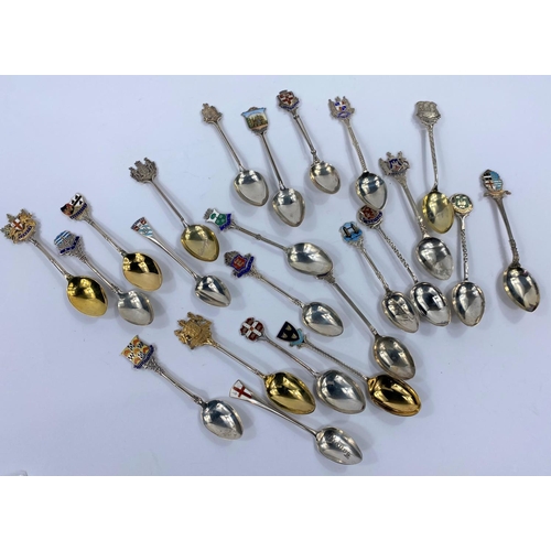 706 - An early 20th century collection of 24 silver souvenir spoons, most with enamelled finials, 10 oz gr... 