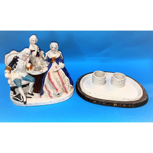 579 - A Dresden style china two bottle ink stand, the cover in the form of figures playing chess, length 7... 