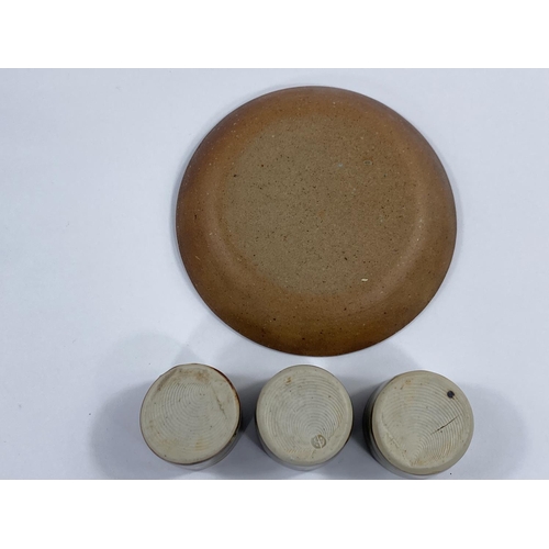512 - BERNARD LEACH, 3 brown stoneware egg cups and circular stand, impressed mark