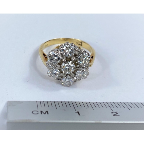672 - A yellow metal ring with 7 old cut diamonds in cluster setting, stamped '18 ct', size H