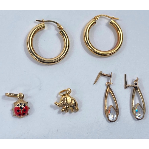 640 - A pig charm; a ladybird charm; a pier of crystal set drop earrings and a pair of gypsy earrings, all... 