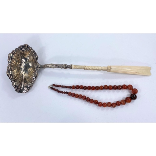 717 - A amber coloured agate bead necklace and a whale bone and white metal handled punch ladle (a.f.)