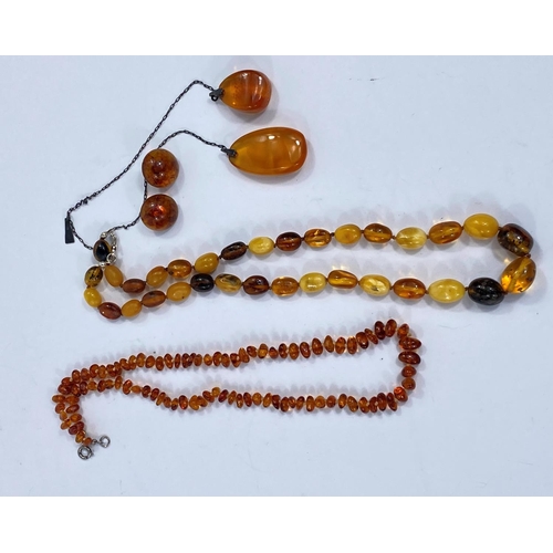 719 - A necklace of butterscotch amber coloured beads and other similar costume jewellery