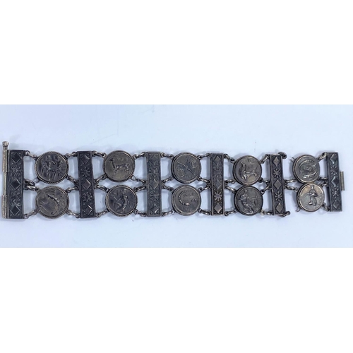 721 - A late 19th / early 20th century white metal bracelet with double row of circular medallions depicti... 