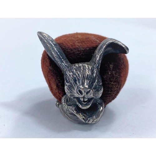 725A - A novelty white metal pin cushion in the form of a rabbit