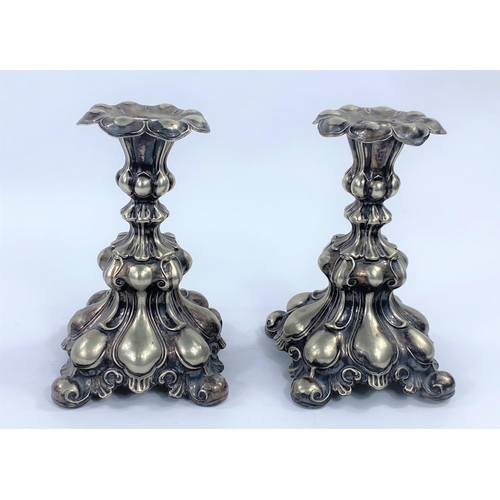 726 - A pair of Rococo style, white metal candlesticks, height 17cm.