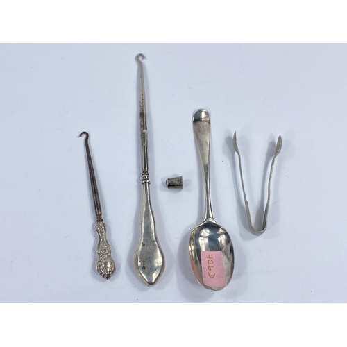 726D - A Georgian silver table spoon (mark rubbed); a white metal thimble etc.