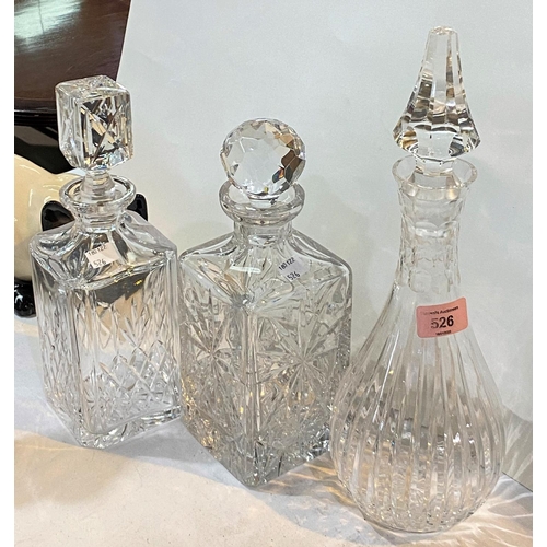 526 - A baluster cut glass decanter with sliced decoration; 2 square cut glass decanters all with stoppers