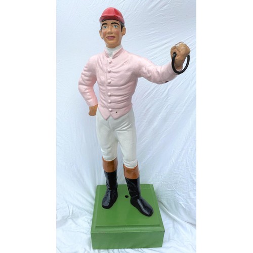 195 - A late 19th / early 20th century cast iron 'hitching post' / Lawn Jockey in the form of a jockey in ... 