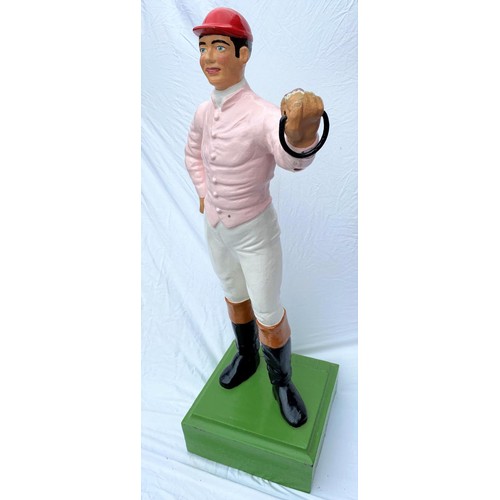 195 - A late 19th / early 20th century cast iron 'hitching post' / Lawn Jockey in the form of a jockey in ... 
