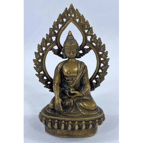 415 - A Far Eastern bronze figure of a seated buddha with pierced leaf shaped back rest, height 15cm