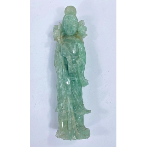 424 - A Chinese hardstone figure of a sage holding a large flower, height 26cm (some areas of loss)