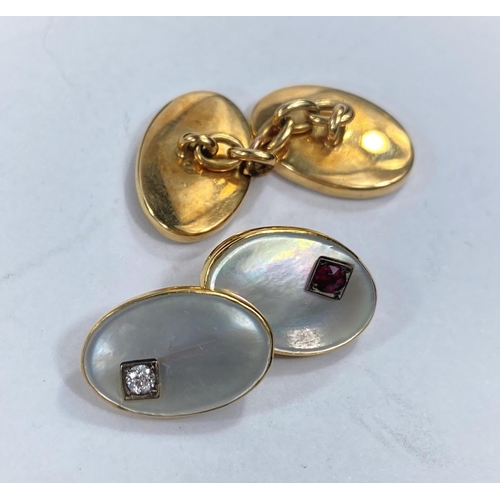 715a - A pair of yellow metal cufflinks with oval mother of pearl insets, diamond and ruby mount to each, i... 