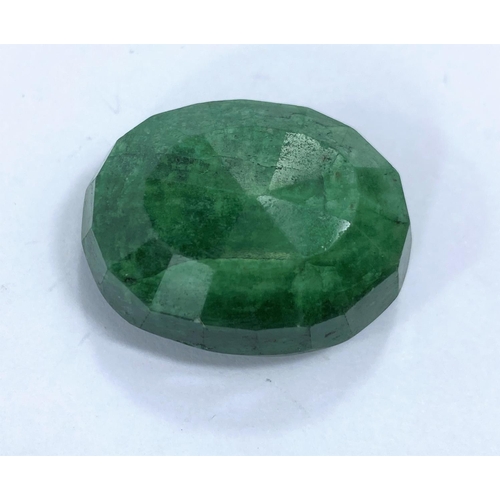 718b - A large unmounted emerald with facetted cuts, approximately 65 carats, 15.5gm, 29mm length
