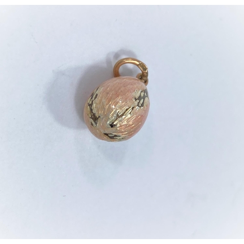 718c - A small pink enamelled Russian style egg pendant / charm in the Faberge manner, stamped to loop A W,... 