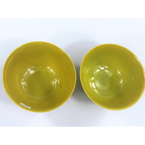 428 - A pair of Chinese yellow glaze rice bowls, on hardwood stands, with seal mark to bases, diameter 12.... 