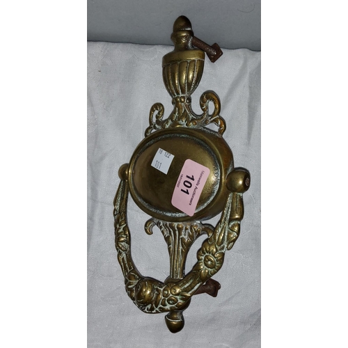 101 - A heavy brass door knocker with classical vase finial
