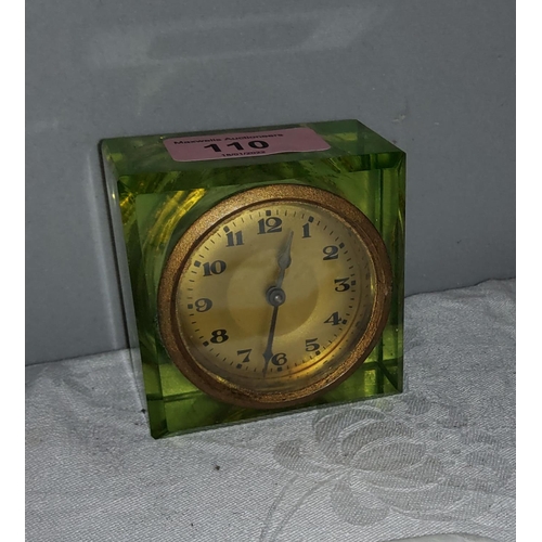 110 - A vintage Uranium glass cased bedside clock with circular gilt dial and Arabic numerals