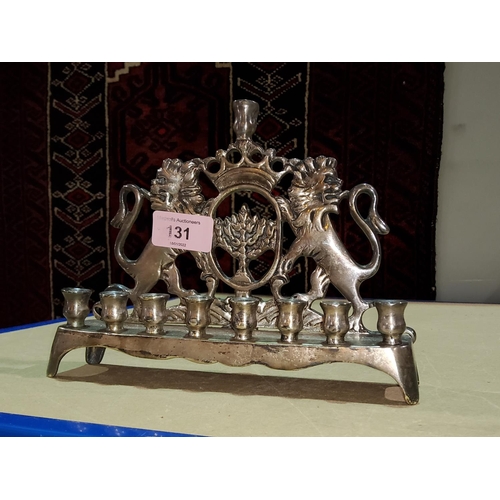 131 - A silvered metal Hanukkah light -Menorah with twin lions rampant width 21cm