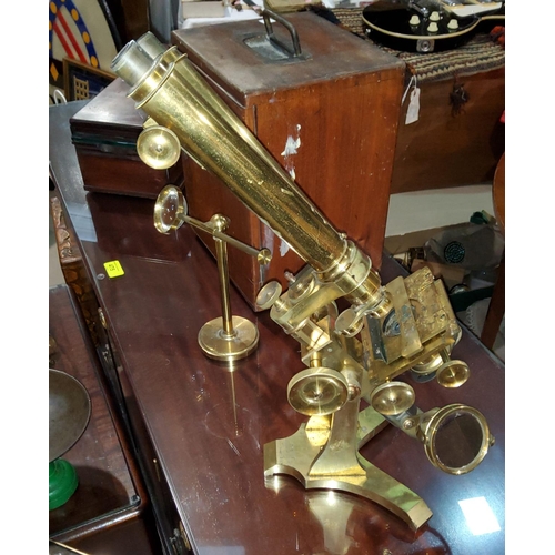 54 - A 19th century brass binocular microscope by J Swift, University St, London W.C., with one inch and ... 