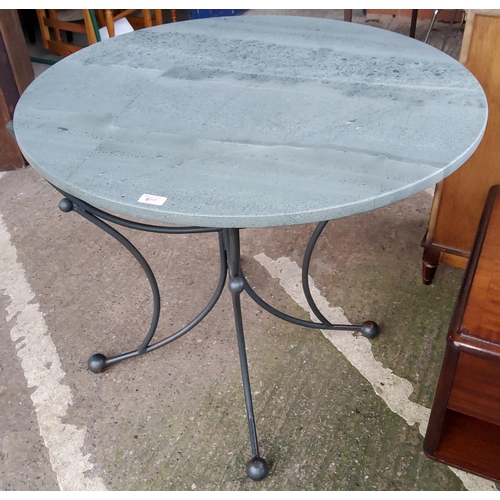 827 - A breakfast table with circular slate top on 4 wrought metal legs