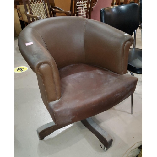 841 - A swivel, tub shaped office arm chair in brown upholstery