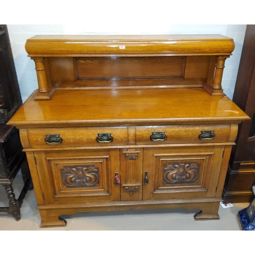 909 - An Edwardian golden oak buffet sideboard with raised back and carved decoration, 2 cupboards and 2 d... 