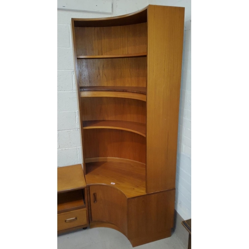 914 - A mid century teak G-plan bow front book case with open shelves over double cupboard below, width 10... 