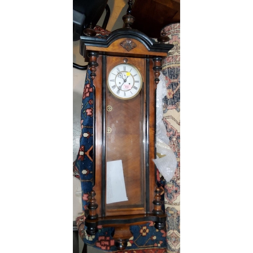 919 - A 19th century Vienna wallclock with turned finials and mounts and a double weight driven striking m... 