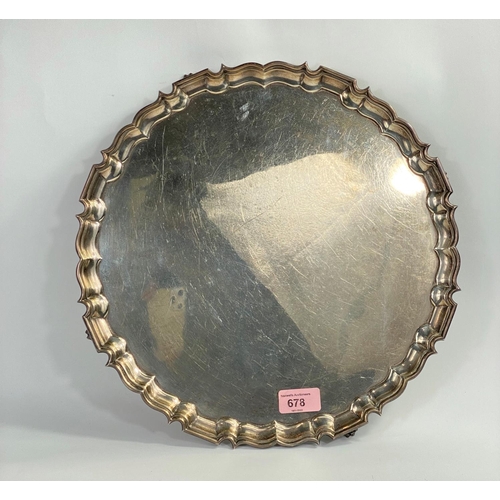 678 - A hallmarked silver  circular salver with raised wavy border, on 4 paw feet, diameter 35 c... 