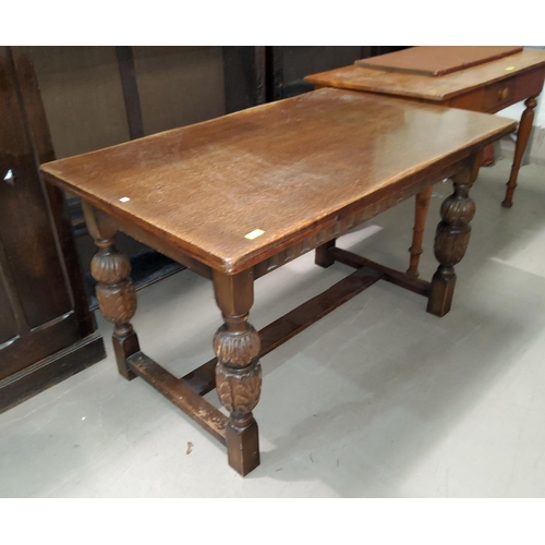 833 - A rectangular period style oak draw-leaf dining table on carved bulbous legs.