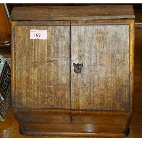 169 - An Edwardian oak slope front correspondence box with fitted interior and perpetual calendar