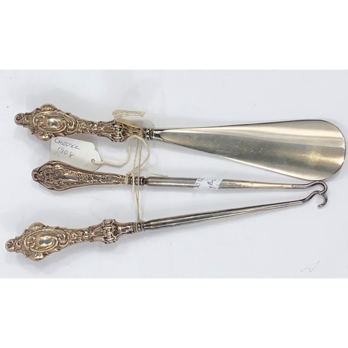 701A - A shoehorn with silver handle; 2 button hooks