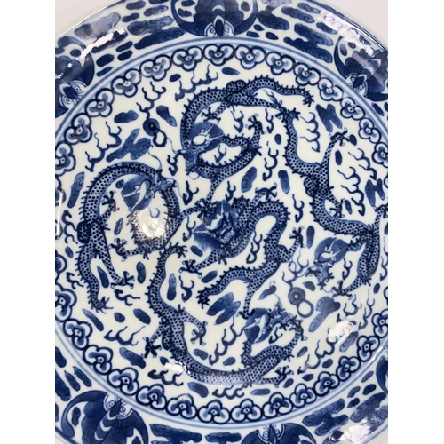 431 - A 19th century Chinese blue and white plate decorated with 5 central dragons and moths / insects to ... 