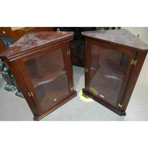 892 - A mahogany pair of small reproduction corner cupboards with glazed doors