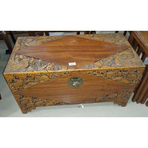 926 - A carved Chinese campher wood chest with detail carving of birds, animals etc.