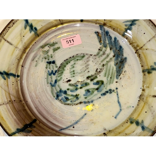 511 - A  studio pottery glazed dish, signed to base, decorated with a bird, diameter 30cm and a carve... 