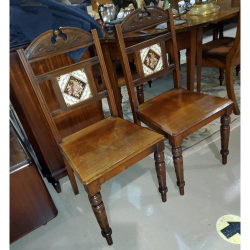 930 - A pair of late Victorian walnut aesthetic design hall chairs, inset tile backs