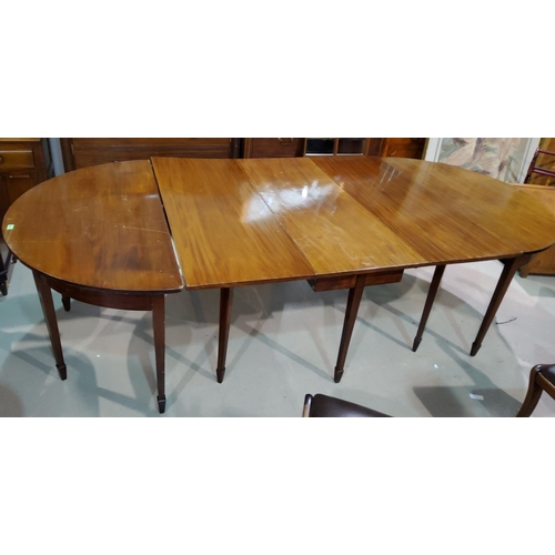 934 - A large mahogany dining table comprising drop leaf central section with two demi lune ends