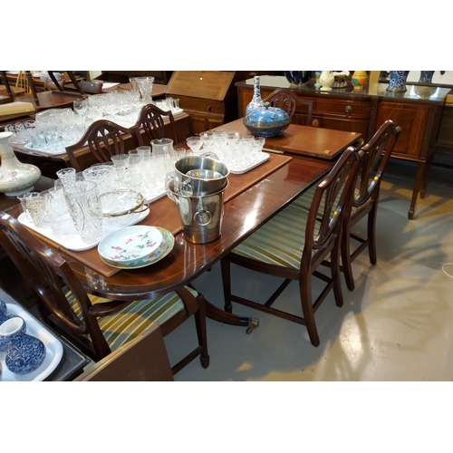 887 - A Georgian style mahogany dining suite comprising twin pedestal table with rectangular extending top... 