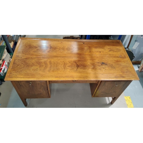 803A - A mid 20th century Continental Rosewood desk with fall front drawer covers with slightly raised back... 